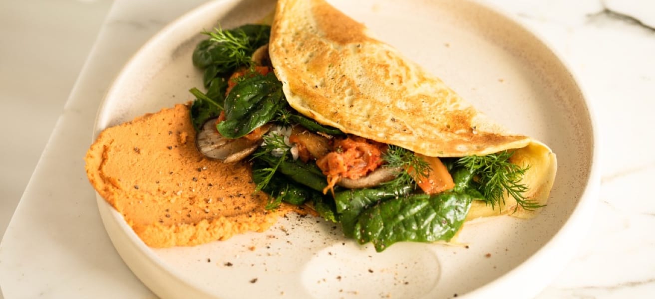 image of an classic omelet on a plate on a marble counter top